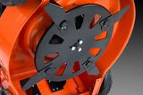 Close-up view of a lawn mower's cutting blades and undercarriage.