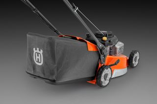 Side view of a Husqvarna lawn mower with a grass collection bag.