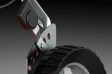 Close-up view of a wheel and metal bracket of a construction or gardening equipment.