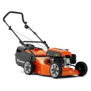 Side view of a Husqvarna lawn mower with visible engine and wheels.