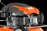 Side view of a Husqvarna lawn mower engine showcasing its components.