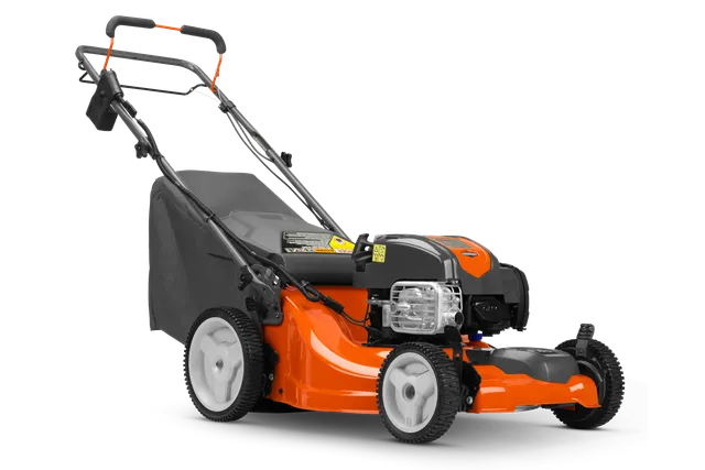 HUSQVARNA L221FHE. Side view of a Husqvarna walk-behind lawn mower with grass collection bag.