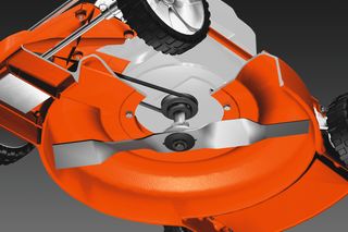 Close-up view of a lawn mower's cutting deck and blade mechanism.