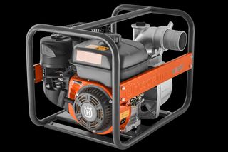 Side view of a Husqvarna water pump with visible engine and piping.