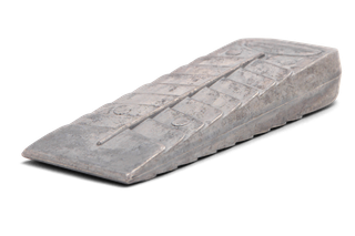 Side view of a metallic wedge used in construction or forestry.