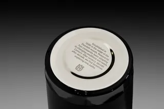 Bottom view of a black ceramic item with a Husqvarna logo and text about its Swedish heritage.