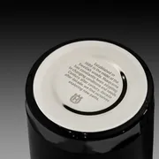 Bottom view of a black ceramic item with a Husqvarna logo and text about its Swedish heritage.