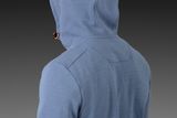 Rear view of a person wearing a hooded garment.