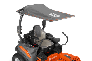 Side view of a Husqvarna ride-on mower with a canopy.