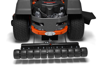 Rear view of a lawn mower with a roller attachment.