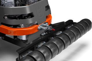 Close-up view of a Husqvarna construction product component with a roller attachment.