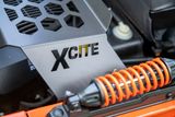 Close-up of a vehicle suspension system with the word 'XCITE' engraved on a metal plate.
