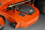 Close-up of a mower's cutting deck with visible components.