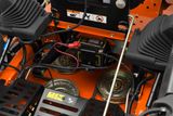 Close-up view of a mower's internal components, including battery and wiring.