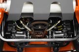 Close-up view of a mower's internal mechanical components, showcasing belts and gears.