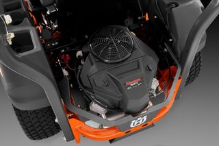 Top view of a ride-on mower's engine compartment, showcasing the Kawasaki engine.