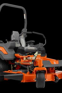 Side view of a Husqvarna zero-turn mower with a cutting deck.