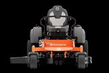 Front view of a Husqvarna zero-turn ride-on mower with visible cutting deck.