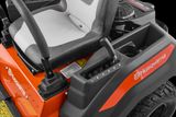 Close-up view of a Husqvarna ride-on mower's control panel and seat.