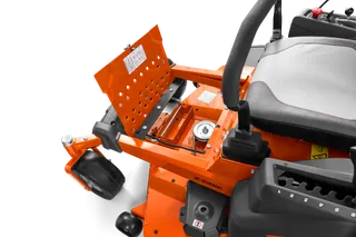 Close-up view of a ride-on mower's battery compartment with the cover open.