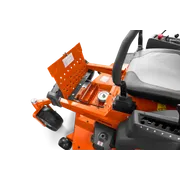 Close-up view of a ride-on mower's battery compartment with the cover open.