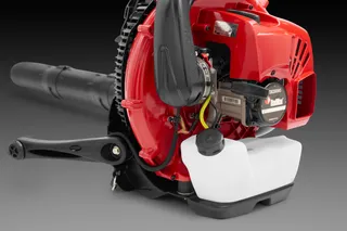 Side view of a leaf blower showing its engine and fuel tank.