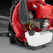 Side view of a leaf blower showing its engine and fuel tank.