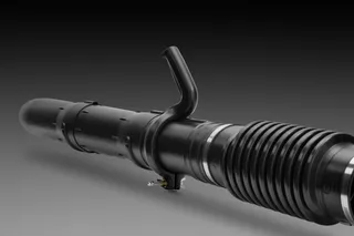 Side view of a construction tool component with a handle and ribbed section.