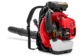 Side view of a leaf blower with visible engine components and shoulder strap.