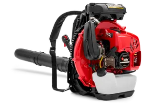 Side view of a leaf blower with visible engine components and shoulder strap.
