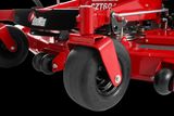 Close-up view of a RedMax commercial mower's wheel and cutting deck.