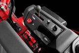 Close-up view of a control panel on a ride-on mower, featuring levers and buttons.