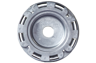 Top view of a circular metal component with multiple slots around the edge.